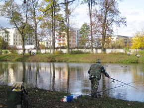 Fisherman at park pond